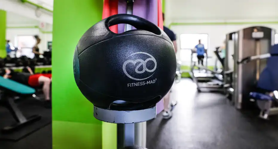 A medicine ball with handles, placed inside one of our gym facilities.